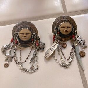 Reminds me of Aztec mythology with the sun, moon, stars, fish. Lots of dangles.